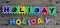 Jigsaw written holiday word on wood background