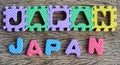 Jigsaw written Japan word on wood background