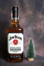 Jim Beam whiskey bottle and a little christmas tree on dark vintage background
