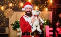 Jingle bells. merry christmas. man santa hat. winter holidays. wait for xmas presents. happy bearded man with bear. new Royalty Free Stock Photo