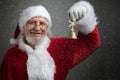 Jingle bells. Santa Claus holding metal bell in his hand