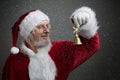 Jingle bells. Santa Claus holding metal bell in his hand