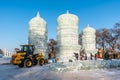 Jinlin, Changchun CHINA - DEC, 27 2018 : Workers are using tractor lifting ice cubes to build ice castles and build snow