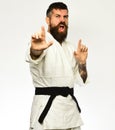Jiu Jitsu master with black belt practices attack, defense posture.