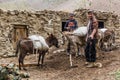 JIZEV, TAJIKISTAN - MAY 17, 2018: Local people with donkeys in Jizev Jisev or Jizeu village in Pamirs mountains