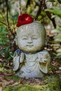 Jizo stone statue wearing knitted and cloth hats.