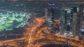 JLT skyscrapers with golf course near Sheikh Zayed Road aerial night timelapse. Residential buildings Royalty Free Stock Photo