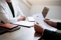 Job applicants are holding a resume document in the job interview room, job interview concept