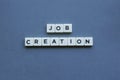 ' Job Creation ' word made of square letter word on grey background