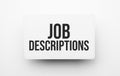 Job Descriptions sign on notepad on the white backgound Royalty Free Stock Photo