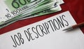 Job Descriptions text, 100 Euro bills. Career development human resources concept Royalty Free Stock Photo