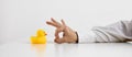 Job dismissal, unemployment or being fired from a work. Businessman hand is about to flick the rubber duckling Royalty Free Stock Photo