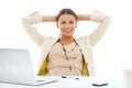 The job is done. Portrait of a pretty young businesswoman leaning back in her chair with her hands behind her head. Royalty Free Stock Photo