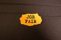 Job Fair text on a yellow sticky note with three clips Royalty Free Stock Photo