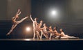 The job of feet is walking, their hobby is dancing. a group of ballet dancers practicing a routine on a stage. Royalty Free Stock Photo