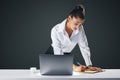 Job and hard work concept with young pretty businesswoman in white classic shirt making notes in her diary leaning on table with Royalty Free Stock Photo