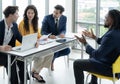 Job interview concept. Employer and diverse hr team doing job interview with a black man in business office. Job candidate talks Royalty Free Stock Photo