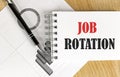 JOB ROTATION text on notebook with pen and chart Royalty Free Stock Photo