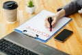 Job search. Female hand writes resume with lipstick on white she