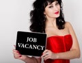 Job vacancy written on virtual screen. technology, internet and networking concept. woman in a red corset holding Royalty Free Stock Photo