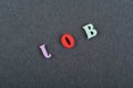 JOB word on black board background composed from colorful abc alphabet block wooden letters, copy space for ad text. Learning Royalty Free Stock Photo