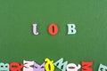 JOB word on green background composed from colorful abc alphabet block wooden letters, copy space for ad text. Learning english Royalty Free Stock Photo