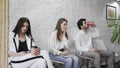 Jobless business people applicants group sitting in chairs in queue line row waiting for their turn company job Royalty Free Stock Photo