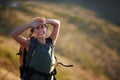 Jobs fill your pockets but adventure fills the soul. Shot of a beautiful young woman wearing a backpack while out hiking