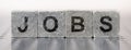 Jobs printed on stony cube Royalty Free Stock Photo