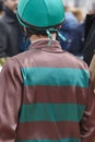 Jockey detail before the race. Hippodrome background. Racehorse.