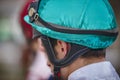 Jockey head detail before the race. Hippodrome background.