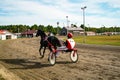 Jockey and horse. Trotting horse race. Race in harness with a sulky or racing bike. Harness racing. Trotting horse race Royalty Free Stock Photo