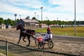 Jockey and horse. Trotting horse race. Race in harness with a sulky or racing bike. Harness racing. Trotting horse race. Royalty Free Stock Photo