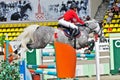 Jockey jumps over a hurdle at the competition