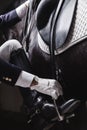 Jockey prepearing horse for the equestrian ride Royalty Free Stock Photo