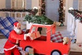 Funny Santa Claus reading children desires on tablet and checkin