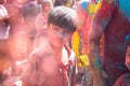 Jodhpur, rajastha, india - March 20, 2020: Portrait of cute little indian kid celebrating holi festival, closeup of face covered