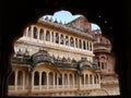 Impressive facade seen from an arch of the Mehrangarh Fort in the blue city of Jodhpur, India