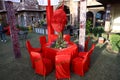 Jodhpur, Rajasthan, India, August 20th, 2020: Organized red table and chairs with flowers ready for the guests sitting in backyard