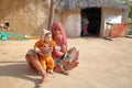 JODHPUR, RAJASTHAN, INDIA - DECEMBER 16, 2017: Portrait of an old woman with a baby in a Bishnoi village near Jodhpur Royalty Free Stock Photo