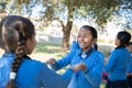 Jodhpur, rajasthan, india - Decemvber 18th, 2019: CloseUp Of Indian asian happy school girls holding hands and playing in a garden