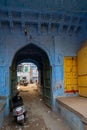 Jodhpur, Rajasthan, India - October 21st, 2019 : Traditional opened wooden door and blue coloured house. Hindu Brahmins used to