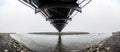 Joekulsarlon Glacier Lagoon channel bridged by suspension bridge washing icebergs towards Diamond Beach in Iceland panorama