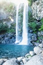 Joengbang waterfall with lens flare from sunlight in Seogwipo, Jeju Island, South Korea Royalty Free Stock Photo