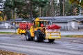 Tractor with a machine for prepares streets for winter