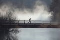 jogger on bridge with fog over river Royalty Free Stock Photo