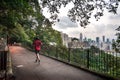 A jogger and a dog walker on Bowen Road, high above Hong Kong Island Royalty Free Stock Photo