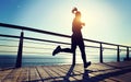 Jogger morning exercise on seaside boardwalk during sunrise Royalty Free Stock Photo