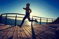 Jogger morning exercise on seaside boardwalk during sunrise Royalty Free Stock Photo