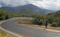 Jogger on serpentine road in mountains